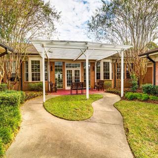 A charming house with a landscaped garden and inviting patio area.