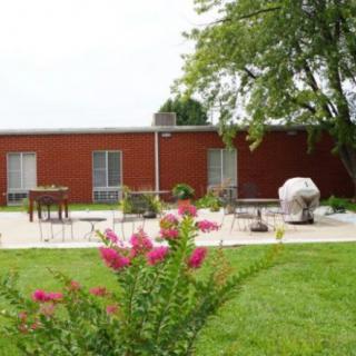A cozy house with a well-maintained garden and patio area.