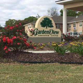 Entrance sign for GardenView surrounded by vibrant landscaping.