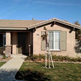 A single-story suburban house with a small front yard.