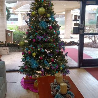 A beautifully decorated Christmas tree in a cozy interior setting.