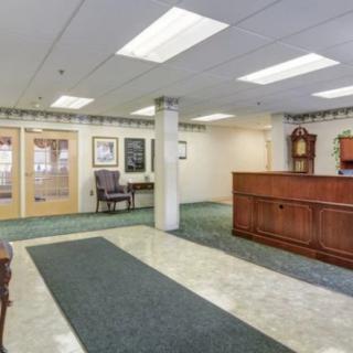 A spacious office lobby with a reception desk and waiting area.
