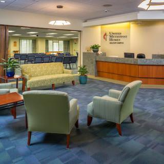 A spacious and comfortable waiting area with seating arrangements and a reception desk.