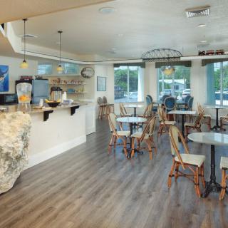 A cozy cafe with neatly arranged tables and chairs, offering a relaxed dining atmosphere.