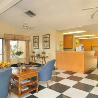 A cozy reception area with a checkerboard floor and comfortable seating.