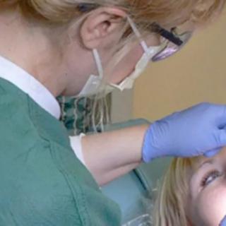 A dentist examining a patient's teeth.