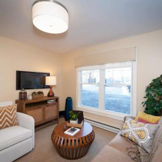 A cozy living room with a modern coffee table, comfortable seating, and stylish decor.