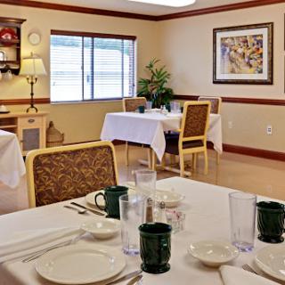 A cozy dining area featuring neatly arranged tables and a warm atmosphere.