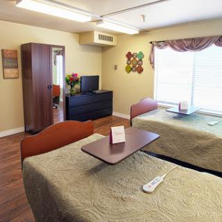 A comfortable and well-lit hospital room with two beds, designed for patient comfort.