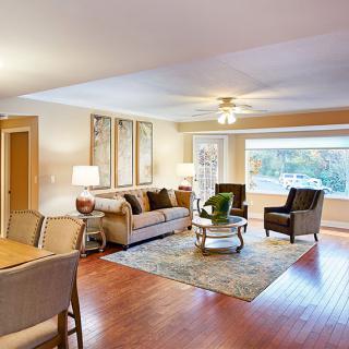 A cozy living room with comfortable seating and ample natural light.