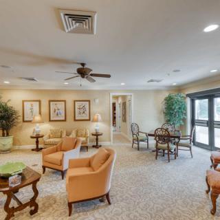 A spacious living room with comfortable seating, tables, and elegant decor.