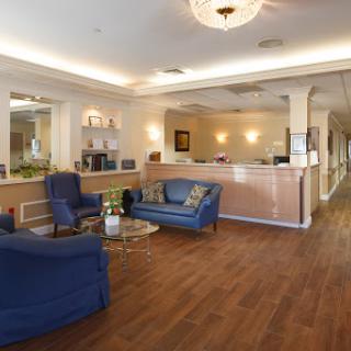 A welcoming lobby space with blue seating and a reception area.