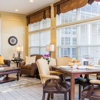 A cozy and modern living room filled with natural light, featuring comfortable furniture and a stylish seating area.