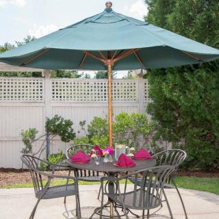 Outdoor patio set with table, chairs, and a large umbrella.