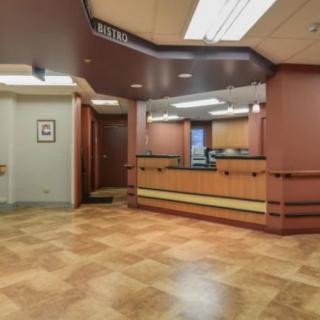 A modern reception area with a desk and warm lighting.