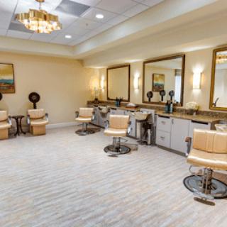 A modern salon interior featuring multiple styling chairs and mirrors, well-lit with chic lighting.