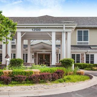 Entrance of a residential building with well-maintained landscaping.