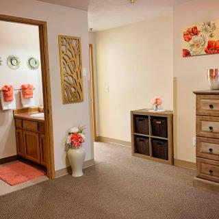 A cozy hallway with decorative elements and a view into a bathroom.