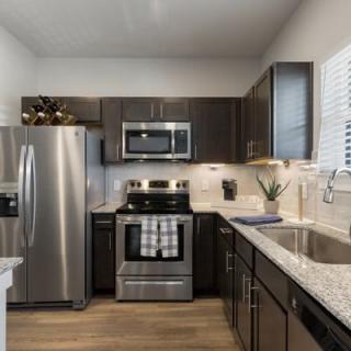 A modern kitchen featuring stainless steel appliances and granite countertops.