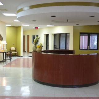 A spacious and modern reception area with a curved desk.