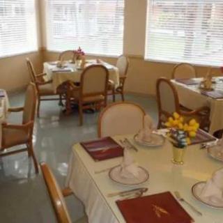 A cozy dining room with elegantly set tables and comfortable chairs.
