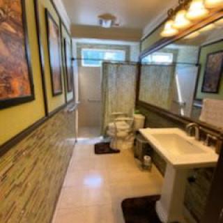 A well-decorated bathroom with modern amenities, including a sink, toilet, and shower.