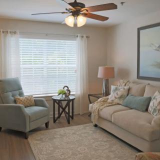 A cozy living room with a sofa, armchair, and decor elements creating a welcoming atmosphere.