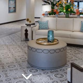 A modern living room with a circular coffee table and a comfortable white couch, featuring stylish decor.