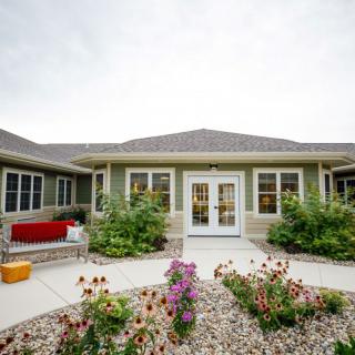 A charming house with a well-maintained garden and colorful flowers along the pathway.