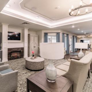 A modern living room with stylish furniture, a fireplace, and elegant lighting.