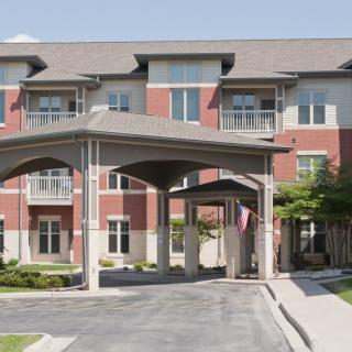 A residential apartment building with a covered entrance.