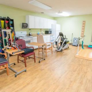 A well-equipped physical therapy room with various rehabilitation tools and exercise machines.