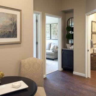 A cozy interior view showcasing a dining area, hallway, and living room in a well-decorated home.