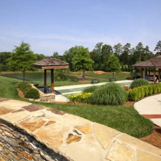 A beautifully landscaped garden with lush greenery, trees, and well-maintained pathways.