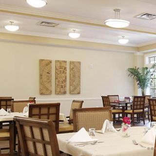 A well-arranged dining area with neatly set tables and classic decor.