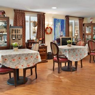 A cozy dining area with classic decor and warmly lit tables.