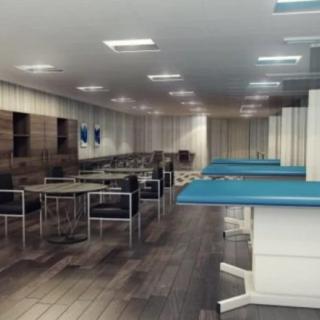 Interior view of a medical facility with multiple treatment beds and chairs.