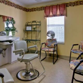 Interior of a hair salon with chairs and a hair dryer.