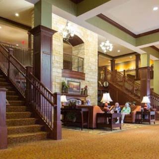 A welcoming lobby featuring elegant wooden architecture and comfortable seating.
