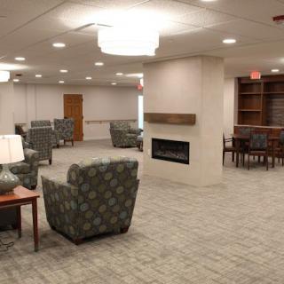 A spacious lobby with comfortable seating and a modern fireplace.