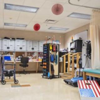 A rehabilitation room equipped with various physical therapy tools and equipment.