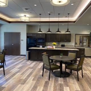 A modern kitchen and dining area with stylish lighting and furniture.