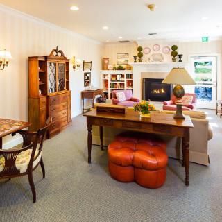 A cozy living room with traditional furniture and a warm fireplace.