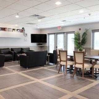 A modern lounge area featuring comfortable seating and a dining space.