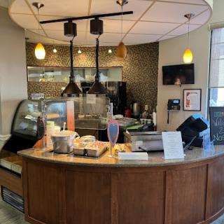 A cozy and modern coffee shop interior featuring a barista counter.