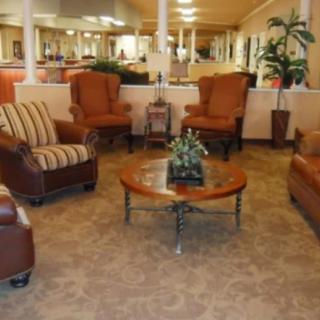 A cozy lobby with comfortable seating and a central coffee table.