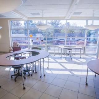 A modern classroom with large windows and stylish furniture.