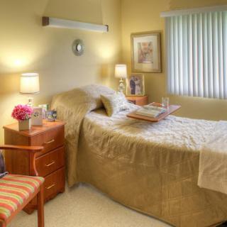 A cozy and inviting bedroom with warm lighting and simple decor.