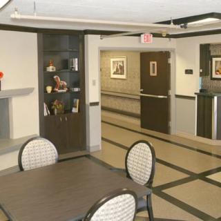 A modern lobby interior with a seating area and hallway.