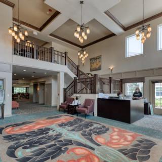 Spacious lobby with elegant decor and grand staircase.